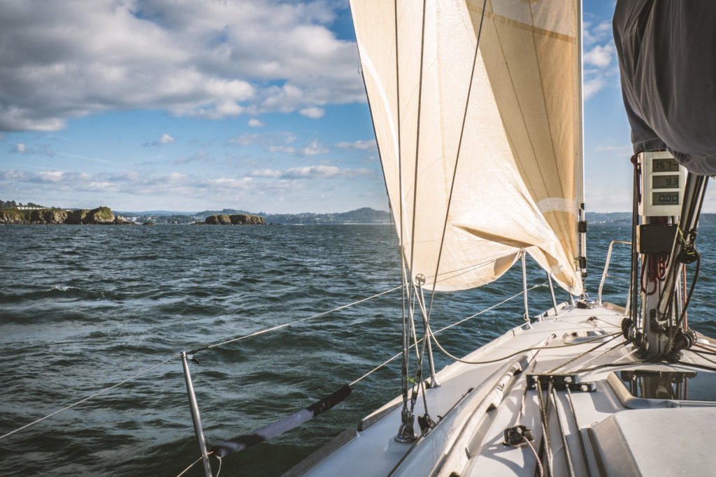 Sailboat in the sea near the coastline